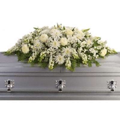 White funeral casket spray with mixed blooms