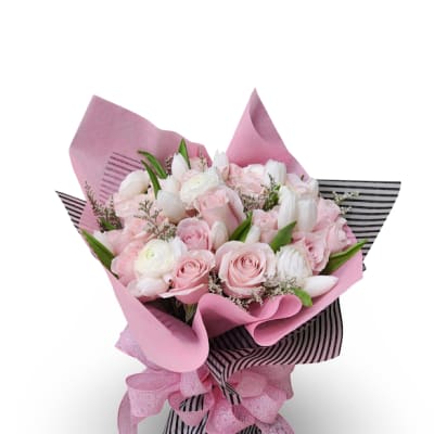 Bouquet of pink and white roses with white tulips wrapped in pink paper