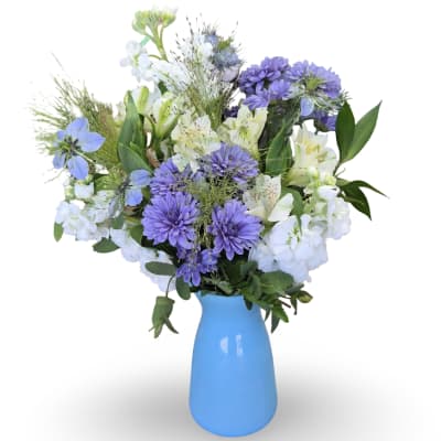 Purple and white mixed bouquet in a blue vase