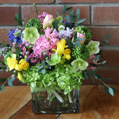 Colorful mixed bouquet in a square glass vase