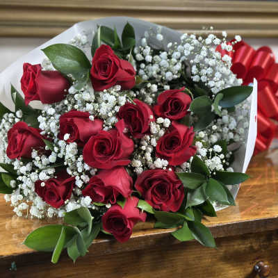 Bouquet of red roses with white baby's breath and a red ribbon