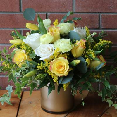 Yellow and white rose bouquet in a gold vase