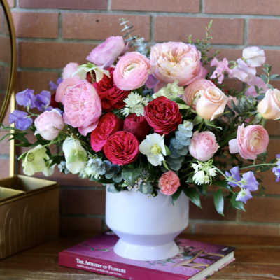 Pink and red mixed bouquet in a white vase