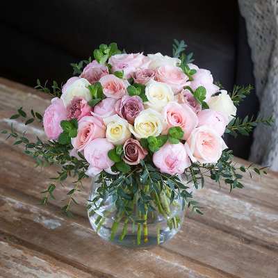 Pink and white rose bouquet in a clear glass vase