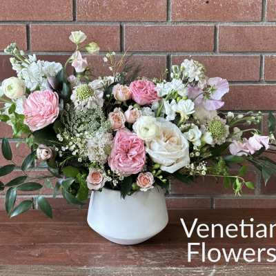 Pink and white floral arrangement in a white vase