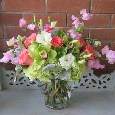 Pink and white floral arrangement in a clear glass vase