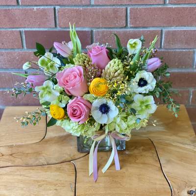 Pink and white mixed bouquet in a glass vase with ribbon