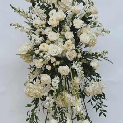 Tall white floral standing spray on an easel