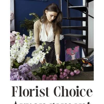 Florist arranging pink and white flowers on a table