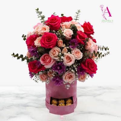 Bouquet of pink and red roses in a pink box with chocolates