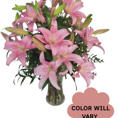 Pink lilies arranged in a clear glass vase