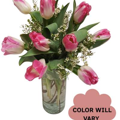 Pink tulips arranged in a clear glass vase