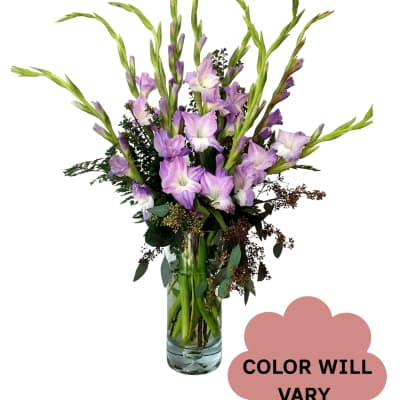 Tall lavender flower arrangement in a clear glass vase