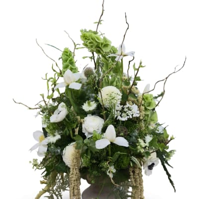 Tall white and green floral arrangement in a pedestal vase