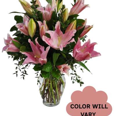 Pink lilies arranged in a clear glass vase