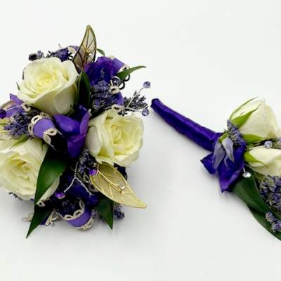 White rose bouquet and matching boutonniere with purple ribbon