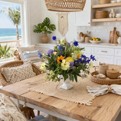 Mixed bouquet in a white pedestal vase on a wooden dining table