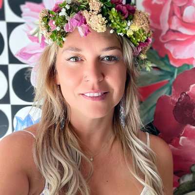 Woman wearing a pink and green floral crown