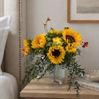 Sunflower arrangement in a textured vase on a bedside table