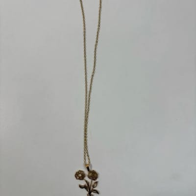 Gold necklace with a small floral pendant