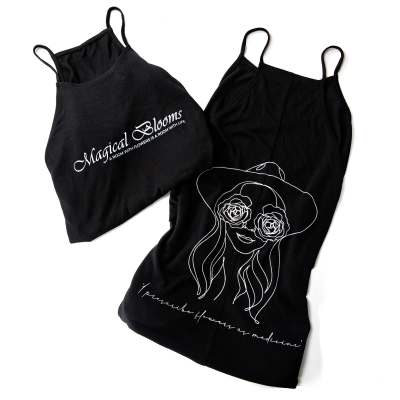 Two black floral-print tank tops with white line art and text