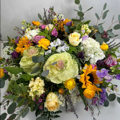 Large mixed bouquet with sunflowers, roses, and cabbage roses