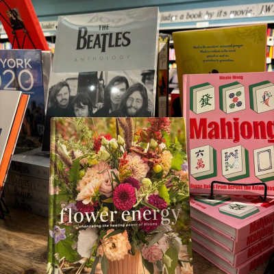 A flower-themed book displayed on a stand in a bookstore.