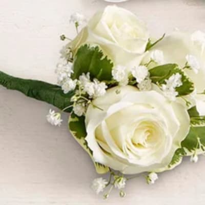 White rose boutonniere with small white filler flowers