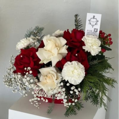 Red and white rose bouquet with carnations and evergreen accents