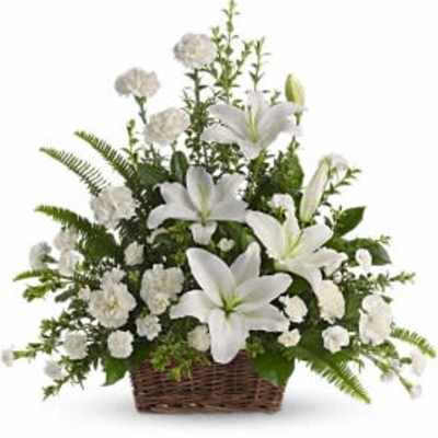 White lilies and carnations in a wicker basket