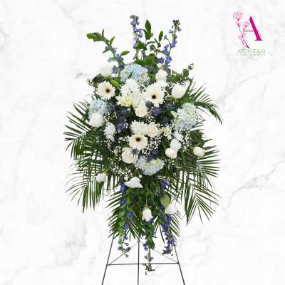 Tall white and blue floral standing spray on an easel