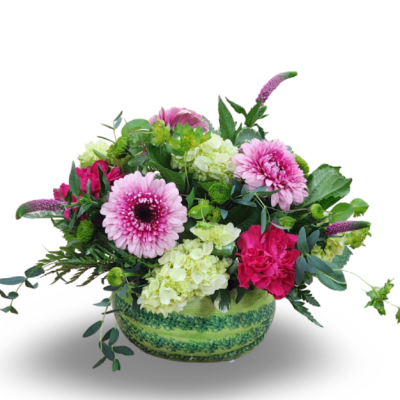 Pink and green mixed flower arrangement in a round green vase