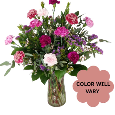 Mixed pink and purple carnations in a glass vase