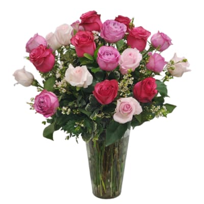 Pink and white roses arranged in a clear glass vase