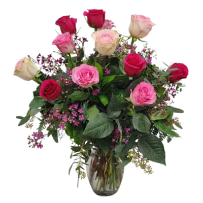 Pink and red roses arranged in a glass vase