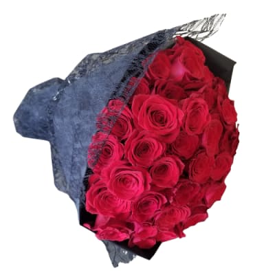 Bouquet of red roses wrapped in dark paper