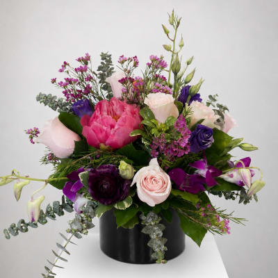 Pink and purple mixed bouquet in a black vase