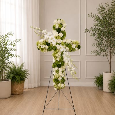 White and green floral cross on a metal stand