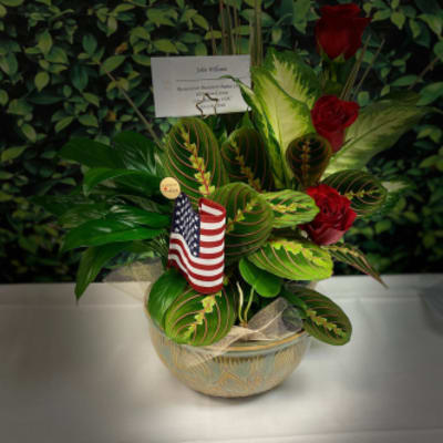 Potted arrangement with red roses and an American flag pick