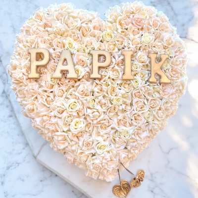 Heart-shaped rose arrangement with gold letters spelling PAPIK