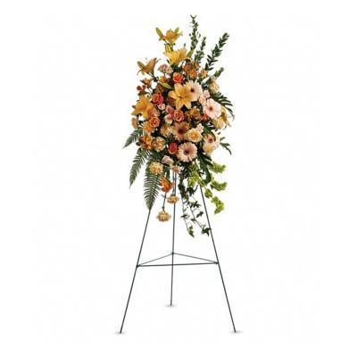 Tall floral standing spray on an easel with orange and peach flowers