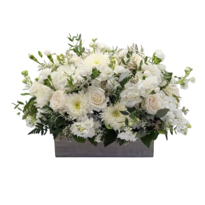 White floral arrangement in a rectangular gray container