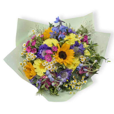 Mixed bouquet with sunflowers, daisies, and purple blooms in pale green wrap