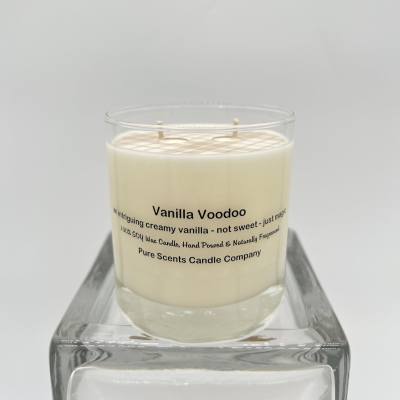 Cream-colored vanilla candle in a clear glass jar on a square glass stand