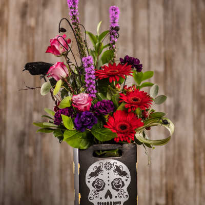 Bright mixed bouquet in a black skull-decorated box