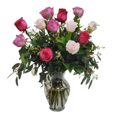 Bouquet of pink and white roses in a clear glass vase