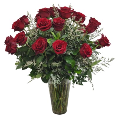 Red roses arranged in a clear glass vase