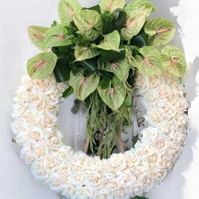 Heart-shaped floral wreath with cream roses and pale green anthuriums