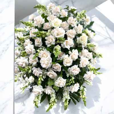 Round bouquet of white roses and green filler flowers