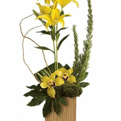 Yellow lilies and orchids in a wooden container